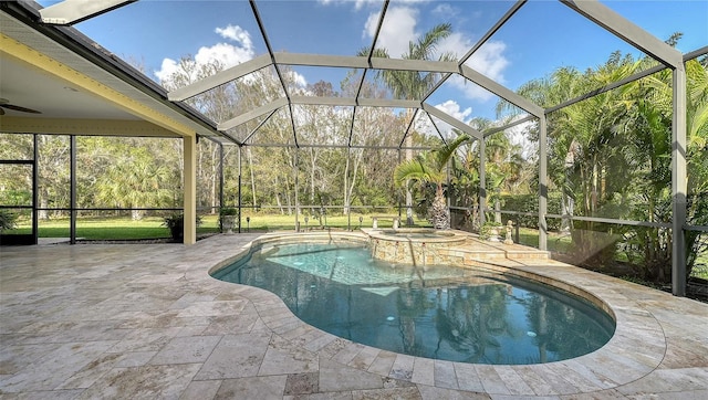 view of swimming pool featuring an in ground hot tub, glass enclosure, ceiling fan, and a patio area