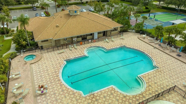 view of swimming pool with a patio area and a hot tub