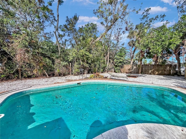 view of swimming pool featuring fence and a fenced in pool