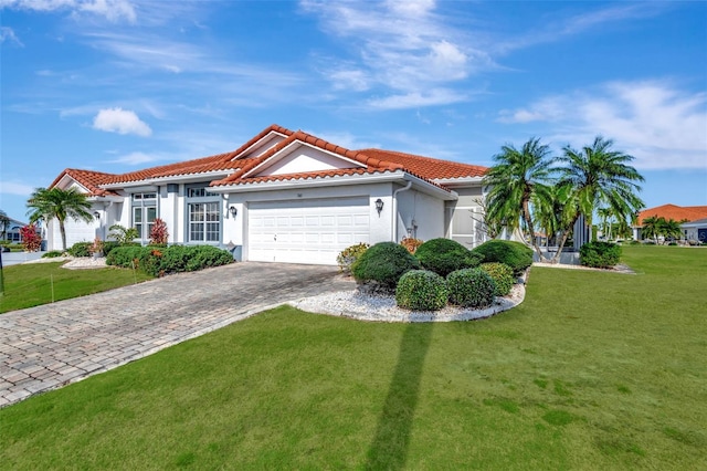 mediterranean / spanish-style home with a garage and a front lawn