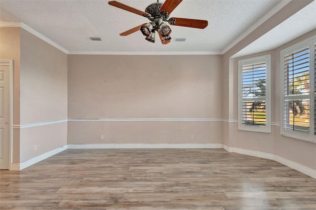 spare room featuring a textured ceiling, ceiling fan, light hardwood / wood-style floors, and crown molding