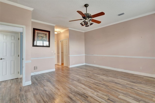 empty room featuring crown molding, ceiling fan, a textured ceiling, and light wood-type flooring