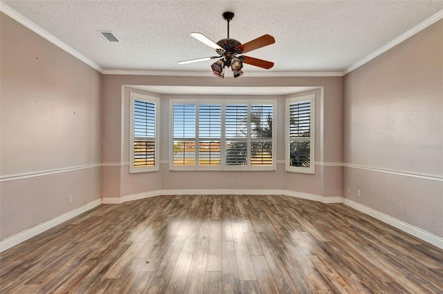 unfurnished room with ceiling fan, wood-type flooring, a textured ceiling, and ornamental molding