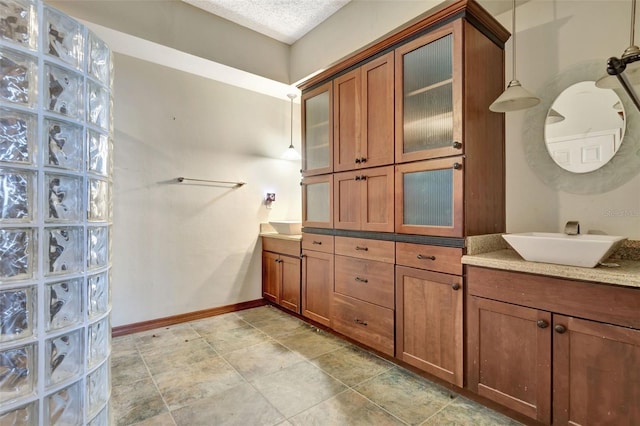 bathroom with vanity and a textured ceiling