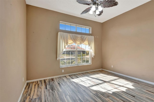 empty room with ceiling fan and light wood-type flooring