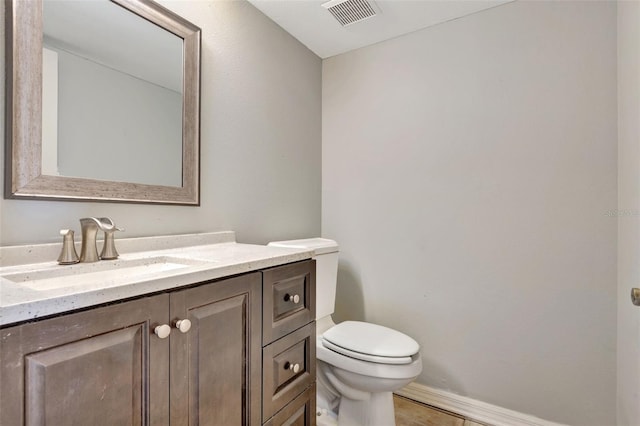 bathroom featuring tile patterned flooring, vanity, and toilet