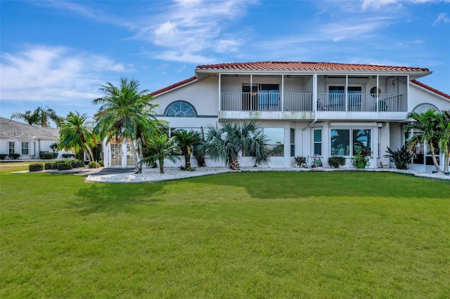 back of house featuring a lawn