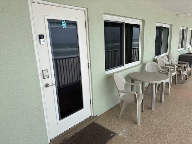 view of exterior entry with stucco siding