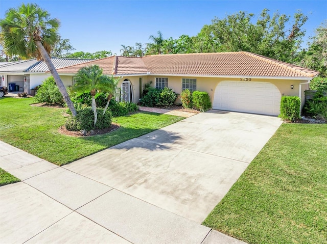 view of front facade with a garage and a front lawn