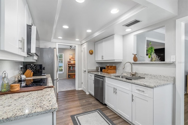 kitchen with white cabinets, dishwasher, light stone countertops, and sink