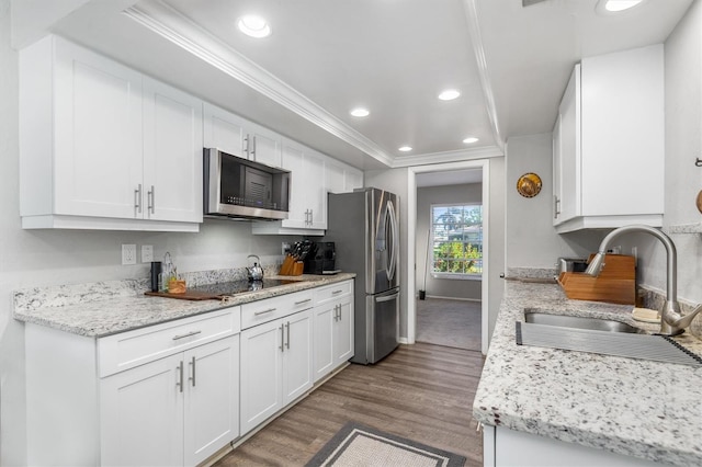 kitchen featuring white cabinets, sink, crown molding, dark hardwood / wood-style flooring, and stainless steel appliances