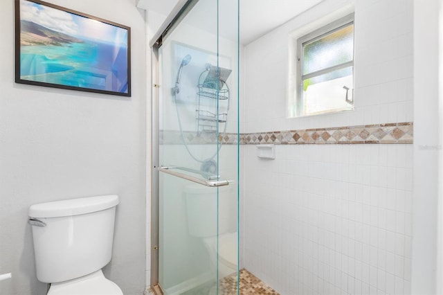 bathroom with an enclosed shower and toilet