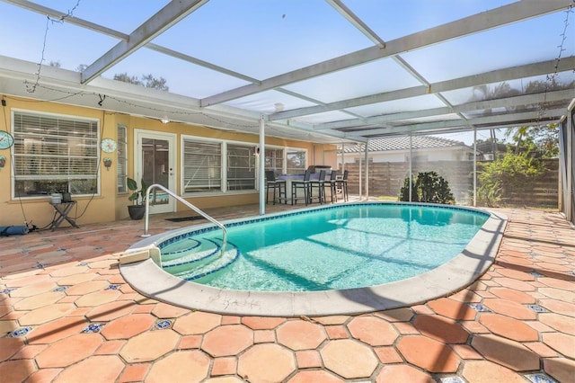 view of pool featuring glass enclosure and a patio area