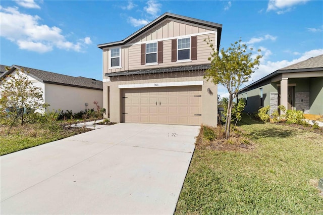 view of front facade with board and batten siding, an attached garage, a front yard, and concrete driveway