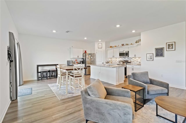 living room with light hardwood / wood-style flooring