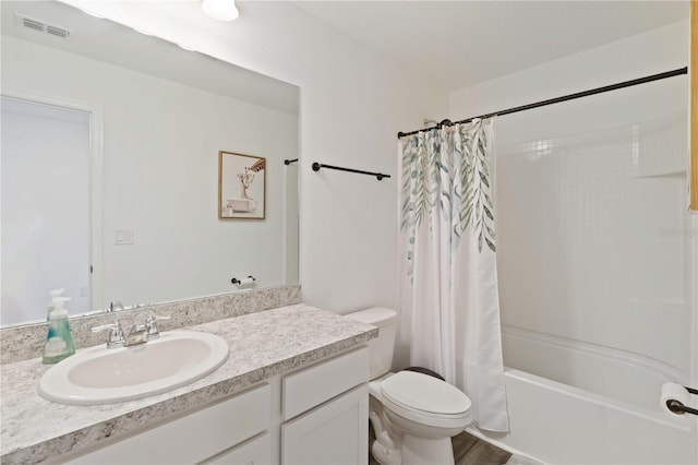 full bathroom featuring vanity, shower / bath combination with curtain, and toilet