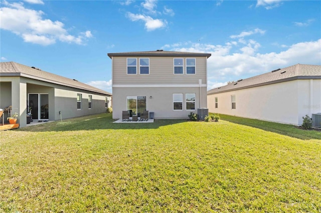 rear view of house featuring a lawn, a patio area, and central AC unit