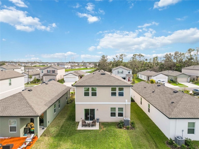 rear view of property featuring a yard, a patio, and cooling unit