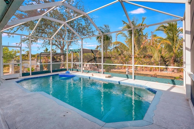 view of swimming pool with a patio and a lanai