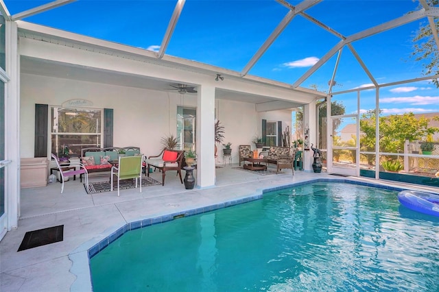 view of pool featuring a lanai, an outdoor living space, and a patio