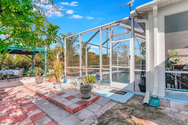 view of patio featuring a lanai