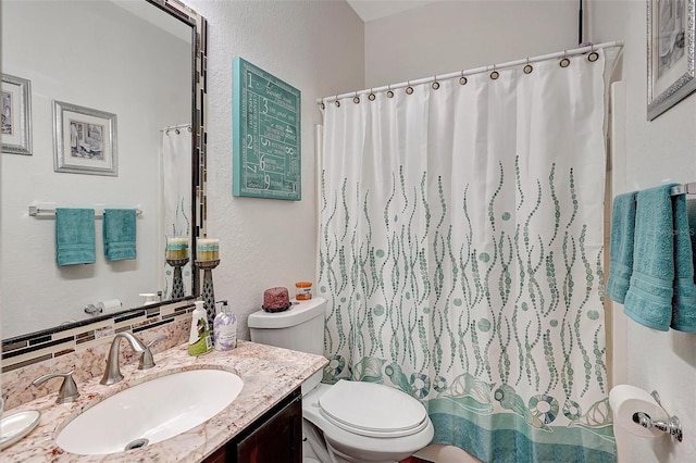 bathroom with decorative backsplash, vanity, toilet, and curtained shower