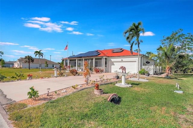 single story home with a front yard, solar panels, and a garage