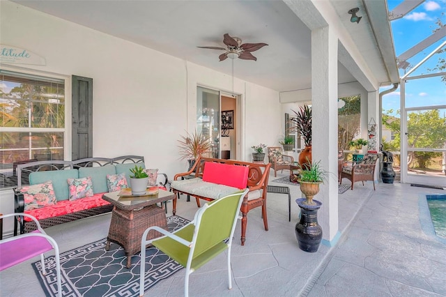 view of patio / terrace with an outdoor hangout area, glass enclosure, and ceiling fan