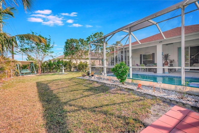 view of yard with a patio and glass enclosure