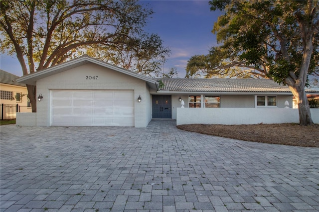 ranch-style house featuring a garage