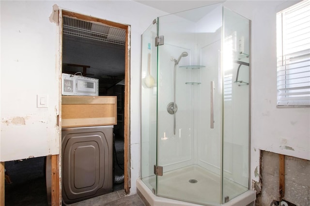 bathroom with tile patterned flooring and an enclosed shower