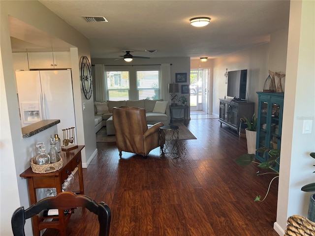 living room with dark hardwood / wood-style floors and ceiling fan