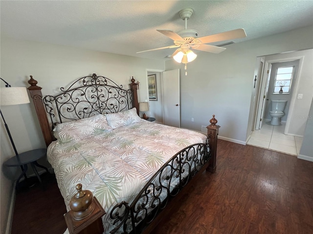 bedroom featuring a textured ceiling, wood-type flooring, ceiling fan, and ensuite bathroom