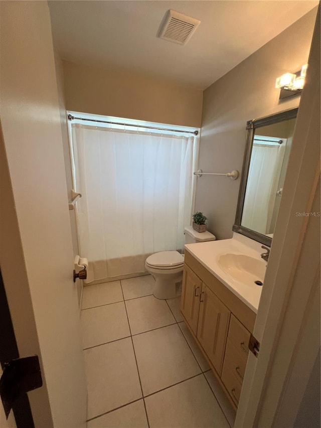 bathroom featuring tile patterned flooring, vanity, and toilet