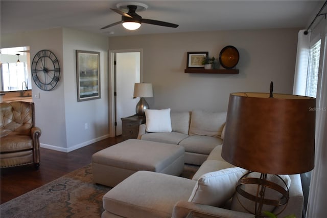 living room with sink, dark hardwood / wood-style floors, and ceiling fan