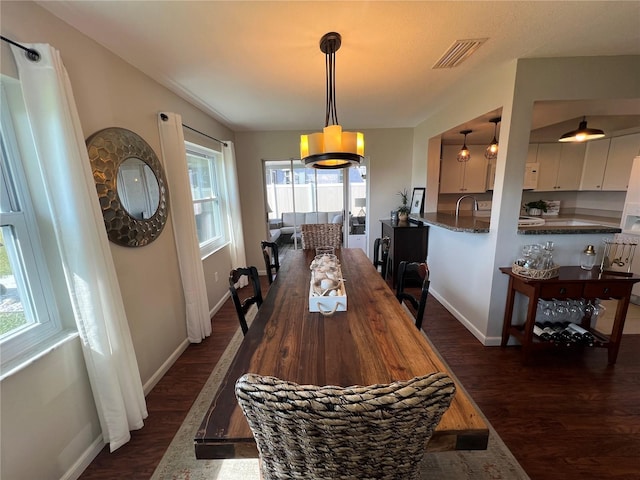 dining room with dark hardwood / wood-style flooring