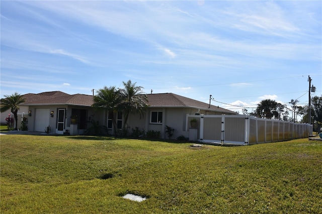 rear view of property featuring a lawn