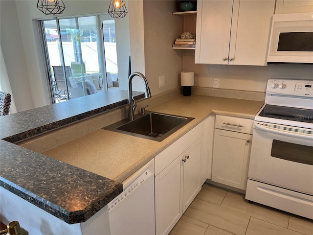 kitchen with white cabinetry, sink, white appliances, and decorative light fixtures