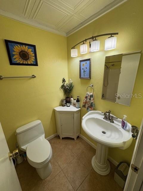 bathroom with tile patterned flooring, toilet, and sink