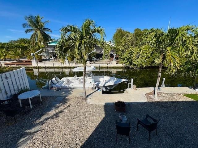 view of yard featuring a boat dock and a water view