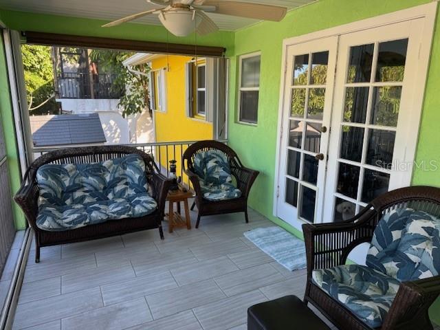 sunroom with ceiling fan and french doors