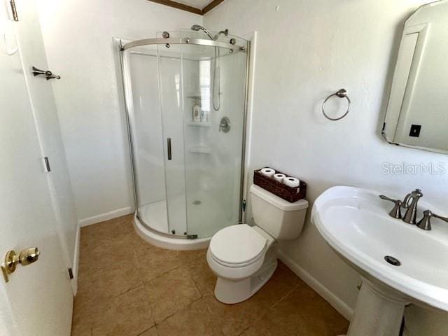 bathroom with sink, tile patterned flooring, toilet, ornamental molding, and a shower with shower door