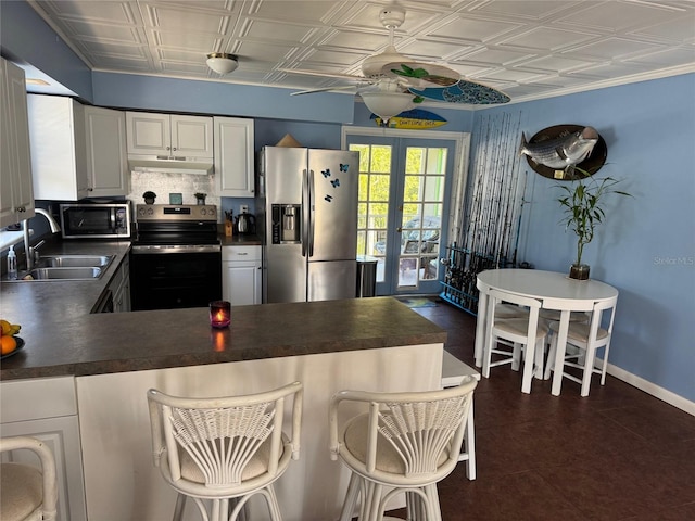 kitchen featuring french doors, white cabinets, sink, decorative backsplash, and stainless steel appliances