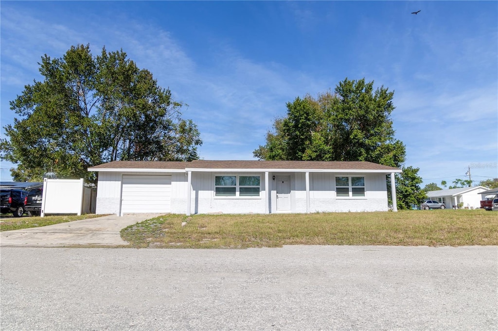 single story home with a front yard and a garage