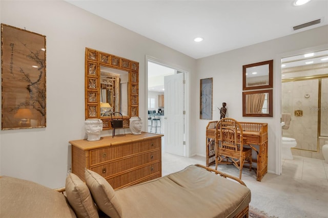 interior space featuring light carpet and ensuite bath