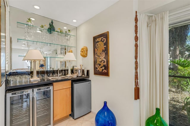 bar featuring refrigerator, sink, wine cooler, light tile patterned floors, and light brown cabinetry