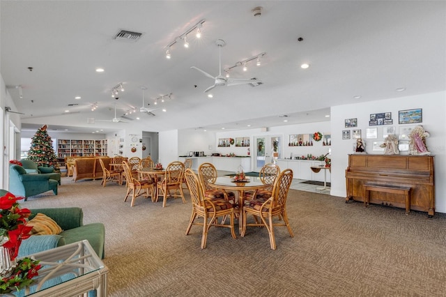 dining area with carpet, ceiling fan, and vaulted ceiling