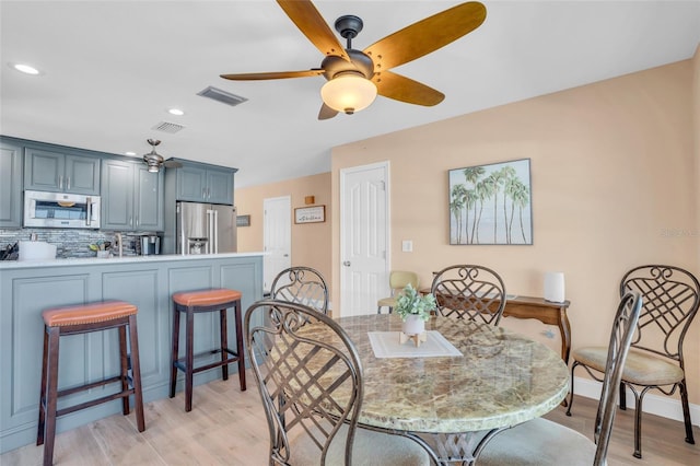 dining space featuring ceiling fan and light hardwood / wood-style flooring