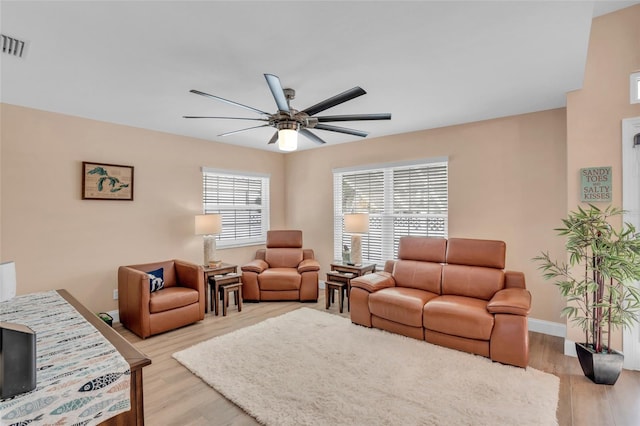 living room featuring ceiling fan and light hardwood / wood-style floors