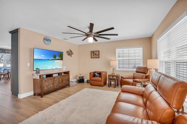 living room featuring ceiling fan and light hardwood / wood-style flooring